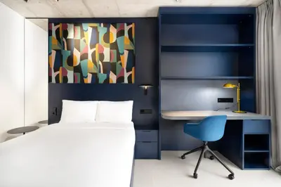 a bedroom with a bed and a desk and a chair at Residencia & Coliving para Postgrads in Barcelona