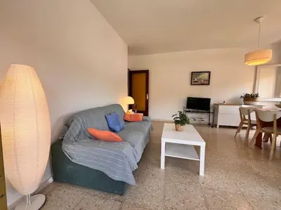 a living room with a couch and a table at Apartamento Montebello in Sant Vicenç de Montalt