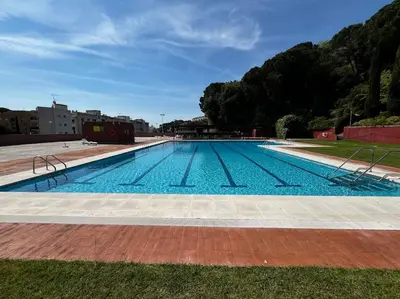 a large swimming pool with blue water at Apartamento Montebello in Sant Vicenç de Montalt