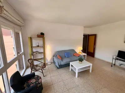 a living room with a couch and a table at Apartamento Montebello in Sant Vicenç de Montalt