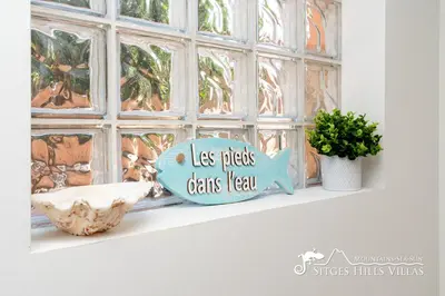 a fish sign that says relax hanging on a wall at Amazing views Villa Alizee with private pool sea views and Air Conditioning in Olivella