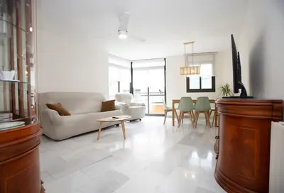 a living room with a couch and a table at Casa tonet in Badalona