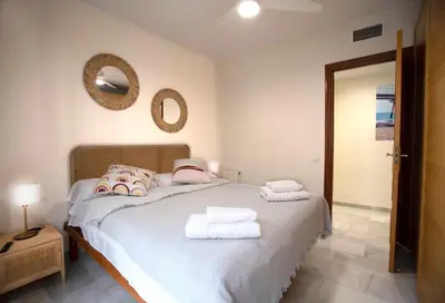 a bedroom with a bed with towels on it at Casa tonet in Badalona