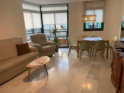 a living room with a couch and a table at Casa tonet in Badalona