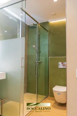 a bathroom with a sink and a toilet at Hotel Boccalino Sitges in Sitges