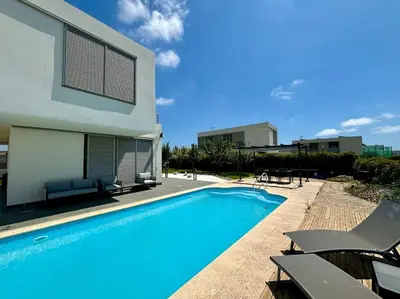 a house with a swimming pool next to a building at Dialez Holidays - Villarenys in Arenys de Mar