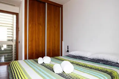 a bedroom with two beds with white pillows on them at Dialez Holidays - Villarenys in Arenys de Mar