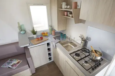 a small kitchen with a sink and a stove at Càmping Bellsol in Pineda de Mar