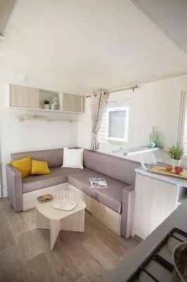 a living room with a couch and a table at Càmping Bellsol in Pineda de Mar