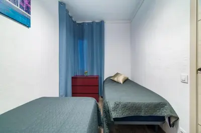 a bedroom with two twin beds and a window at El Nido in Gavà