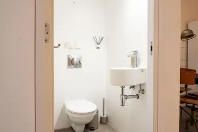 a bathroom with a toilet and a sink at GuestReady - Unique Retreat in Barcelona in Barcelona
