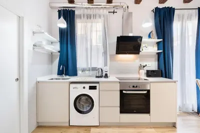 a kitchen with a washing machine and a sink at Lodging Apartments Almirall Beach 32 in Barcelona