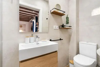 a bathroom with a white sink and a toilet at Lodging Apartments Almirall Beach 32 in Barcelona
