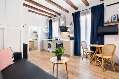 a living room with a couch and a table at Lodging Apartments Almirall Beach 32 in Barcelona