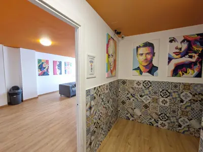 a hallway with art on the walls and a doorway at Arc House Barcelona in Barcelona