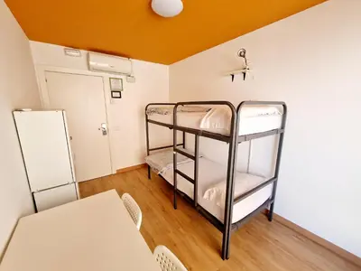 a room with two bunk beds and a table at Arc House Barcelona in Barcelona