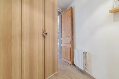 a hallway with a wooden door and a room at GuestReady - Bright apartment with balcony in Barcelona