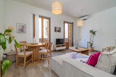 a living room with a couch and a table at GuestReady - Bright apartment with balcony in Barcelona