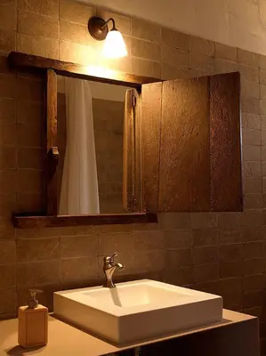 a bathroom with a white sink and a mirror at Ca l'Agnès in Montseny