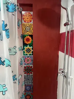 a door with a colorful shower curtain with at Tessasapartments Sabadell 2 in Sabadell