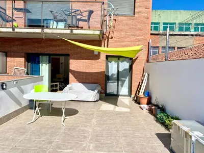 a patio with a table and a yellow canopy on a building at Tranquilo y con terraza in Terrassa
