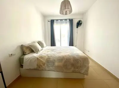 a small bedroom with a bed with a window at Tranquilo y con terraza in Terrassa
