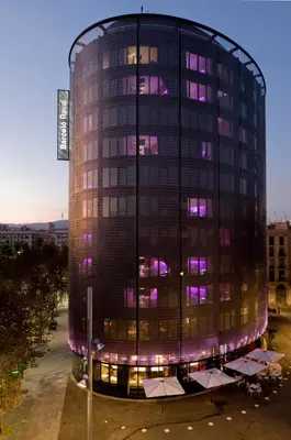a building with purple lights on the side of it at Barceló Raval in Barcelona