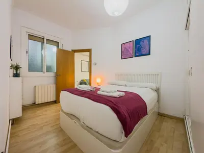 a bedroom with a large bed in a room at GuestReady - Comfortable Retreat next to the beach in Barcelona