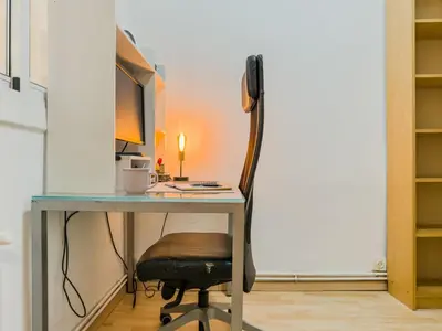 a desk with a computer and a chair at GuestReady - Comfortable Retreat next to the beach in Barcelona
