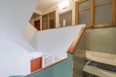 an empty staircase in a room withwindows and a stair case at GuestReady - Comfortable Retreat next to the beach in Barcelona