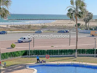 a man and two dogs standing by a swimming pool near the beach at Apartamento marítimo en Cubelles - OI01958 in Cubelles