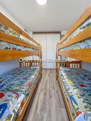 two bunk beds in a room with wooden shelves at Apartamento marítimo en Cubelles - OI01958 in Cubelles