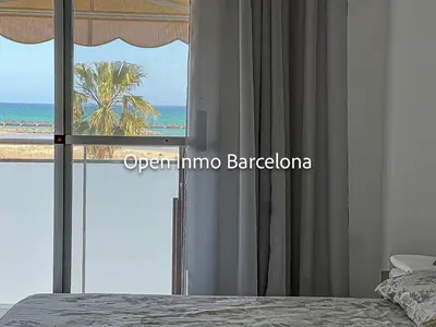 a bedroom with a window with a view of the ocean at Apartamento marítimo en Cubelles - OI01958 in Cubelles