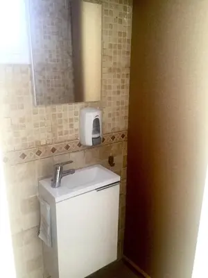 a small bathroom with a sink and a mirror at Apartment Aptucat in Barcelona