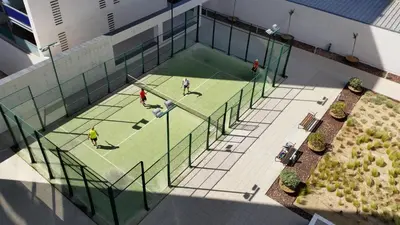 an overhead view of people playing tennis on a tennis court at Apartment Airport Barcelona Premium in Viladecáns
