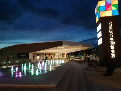 a water fountain in front of a building at night at Apartment Airport Barcelona Premium in Viladecáns