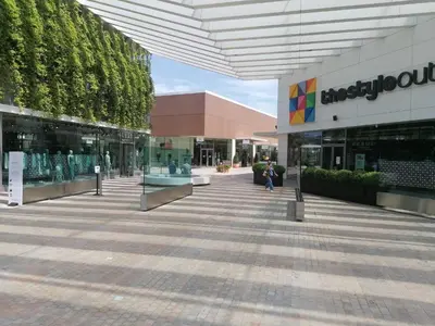 a building with a fountain in front of it at night at Apartment Airport Barcelona Premium in Viladecáns