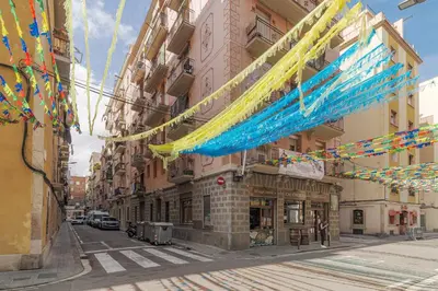 a city street with colorful flags and buildings at GuestReady - Precioso refugio en la Barceloneta in Barcelona