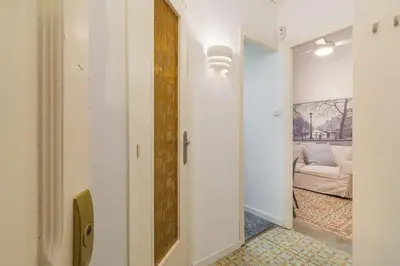 a hallway with a door leading to a living room at GuestReady - Precioso refugio en la Barceloneta in Barcelona
