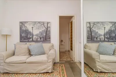 a living room with a couch and a painting on the wall at GuestReady - Precioso refugio en la Barceloneta in Barcelona