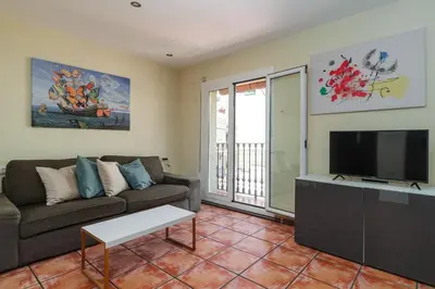 a living room with a couch and a flat screen tv at GuestReady - Un pequeño paraíso en Barcelona in Barcelona