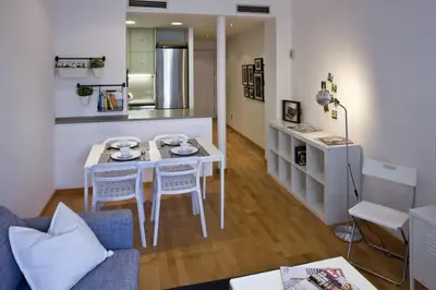 a small living room with a table and chairs at Flateli Llúria in Barcelona