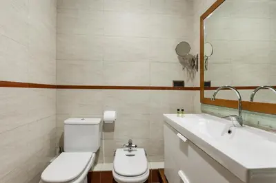 a bathroom with a toilet and a sink and a mirror at Flateli Lepant in Barcelona