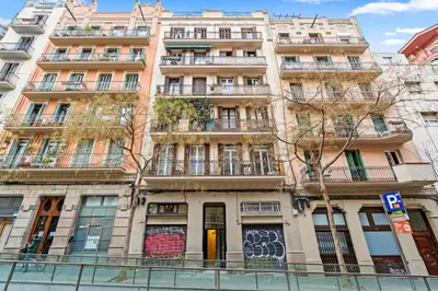 a tall building with balconies on the side of it at Flateli Fabra in Barcelona