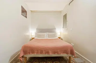a bedroom with a bed in a white room at Flateli Fabra in Barcelona