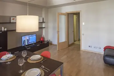 a living room with a dining table and a television at Flateli Mallorca-Passeig de Gracia in Barcelona