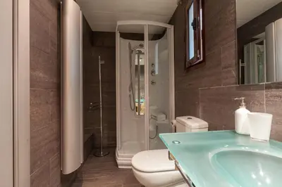 a bathroom with a sink and a toilet and a shower at Flateli Mallorca-Passeig de Gracia in Barcelona
