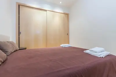 a bedroom with a bed with two towels on it at Flateli Mallorca-Passeig de Gracia in Barcelona