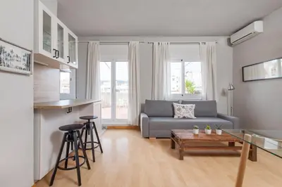 a living room with a couch and a table at Flateli Roger 16 in Barcelona