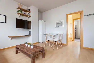 a living room with a table and a dining room at Flateli Roger 16 in Barcelona